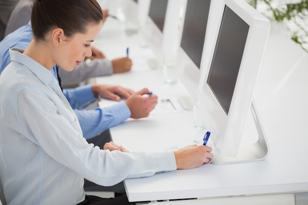 Equipe de negócios escrevendo idéias de brainstorming em seu bloco de notas