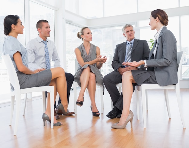 Equipe de negócios sentada em círculo e discutindo