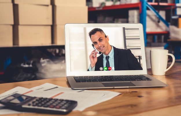 Foto equipe do depósito falando em videochamada na tela do computador no depósito