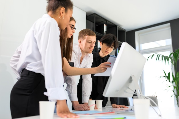 Equipe multicultural estuda documentos no escritório