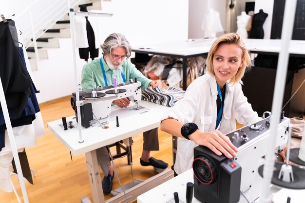 Equipe multiétnica de designers de moda trabalhando em uma oficina de criação de roupas - Grupo multirracial de estilistas, estilistas e costureiras trabalhando em uma nova coleção