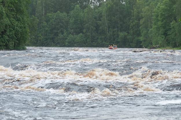 equipo en una balsa pasa los rápidos en el río Shuya