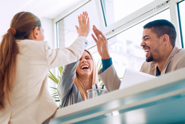 Equipo de negocios feliz celebrando buenas noticias