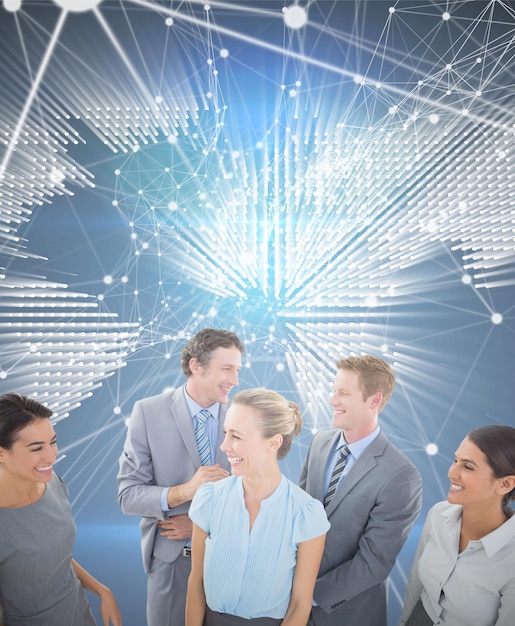 Foto equipo de negocios feliz sonriendo el uno al otro contra el mapa del mundo brillante sobre fondo negro