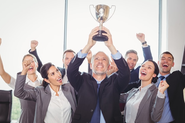 Foto equipo de negocios ganador con un trofeo ejecutivo