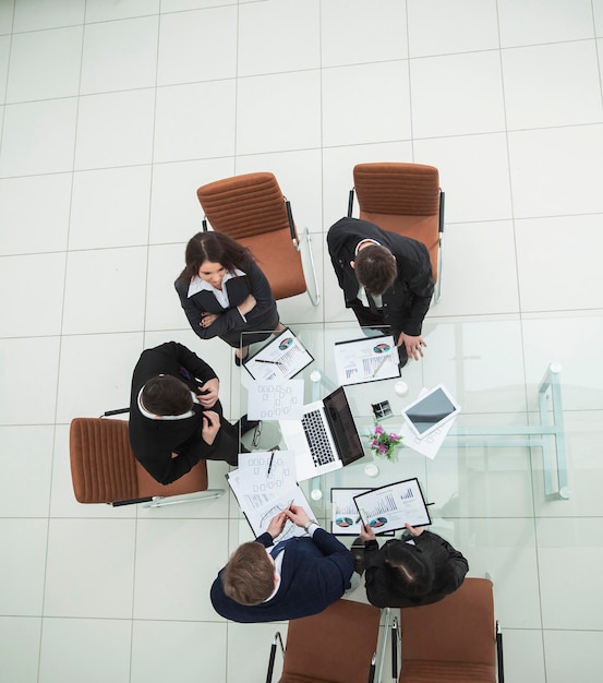 Equipo de negocios en una reunión para discutir las ganancias de los gráficos financieros de la empresa en una oficina moderna