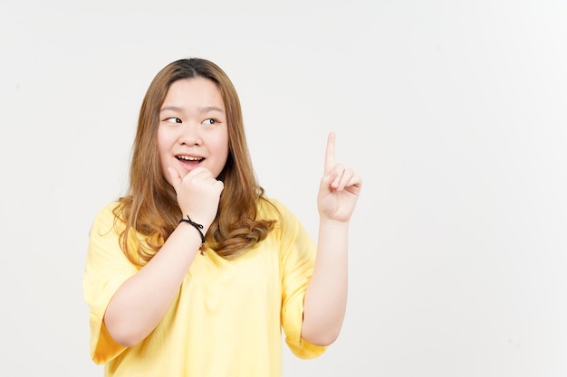 Erhaltene Idee oder Lösung der schönen asiatischen Frau, die das gelbe T-Shirt lokalisiert auf weißem Hintergrund trägt