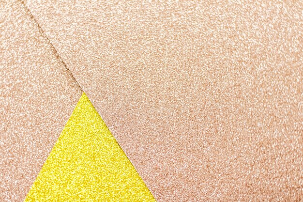 Erröten Sie rosa und gelbes glänzendes Glitterpapierhintergrundzusammenfassungs- und -feiertagshintergrund