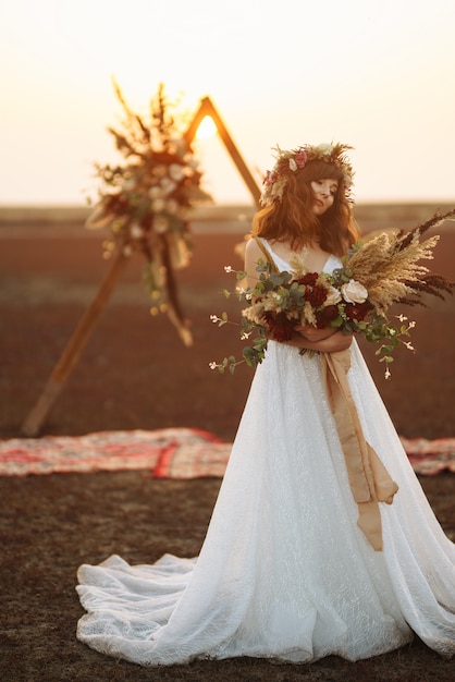 Erstaunliche Braut im Sonnenuntergangslicht. Hübsche Braut. Boho-Stil