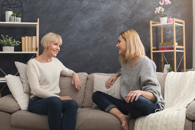 Foto erwachsene mutter und tochter verbringen zeit zusammen, chatten, teilen nachrichten zu hause am wochenende. generationen- und beziehungskonzept