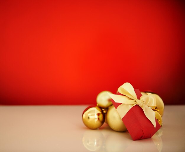 Es una época especial del año Foto de estudio de adornos navideños sobre un fondo rojo