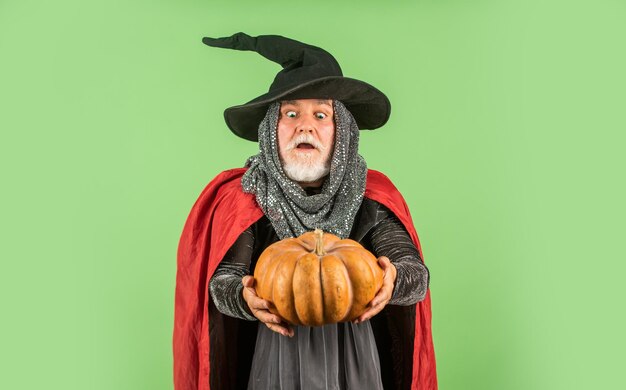 Esto es para mí Viejo abuelo extraño con barba gris Hombre diablo listo para celebrar comida tradicional de Halloween Hombre de Halloween con calabaza Brujo con sombrero y capa feliz Halloween