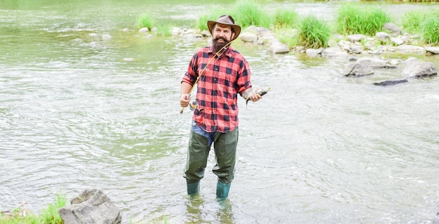 Este es tu lugar pasatiempo y actividad deportiva pescador barbudo en el agua hombre maduro pesca con mosca hombre atrapando peces fin de semana de verano Pescador con mosca exitoso mostrar técnica de pesca usar caña