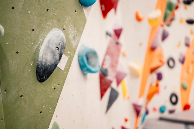 Foto escalador usando equipo de escalada practicando escalada en roca en una pared de roca en interiores deportes extremos y concepto de boulder