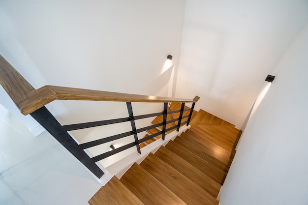 Escalera de madera con iluminación en casa moderna, villa y ático.