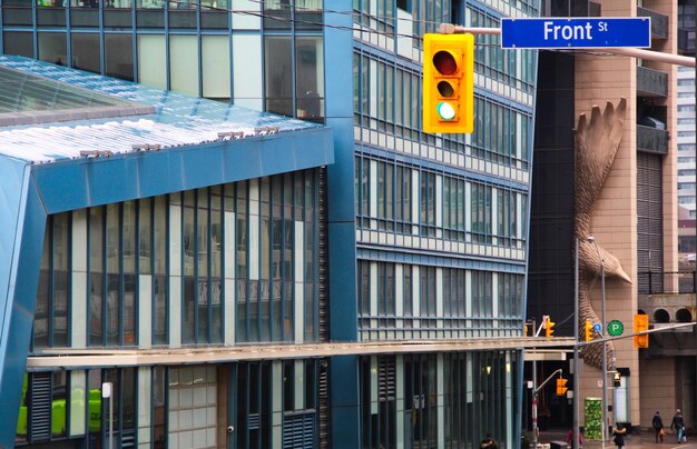 Foto escena de las calles de toronto frente a un pájaro hecho de hormigón que sobresale de la fachada