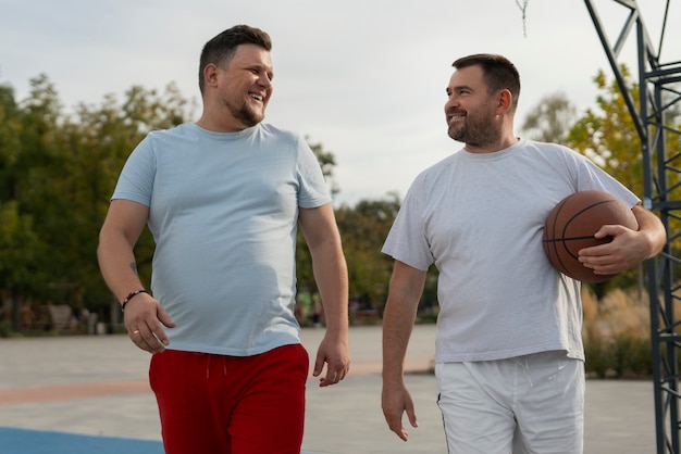 Escenas auténticas de hombres de talla grande jugando al baloncesto