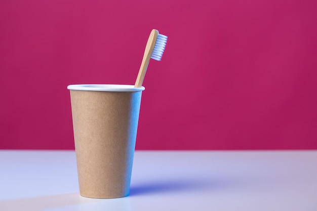 Foto escova de dentes em um copo de papelão ecológico higiene cuidados de saúde