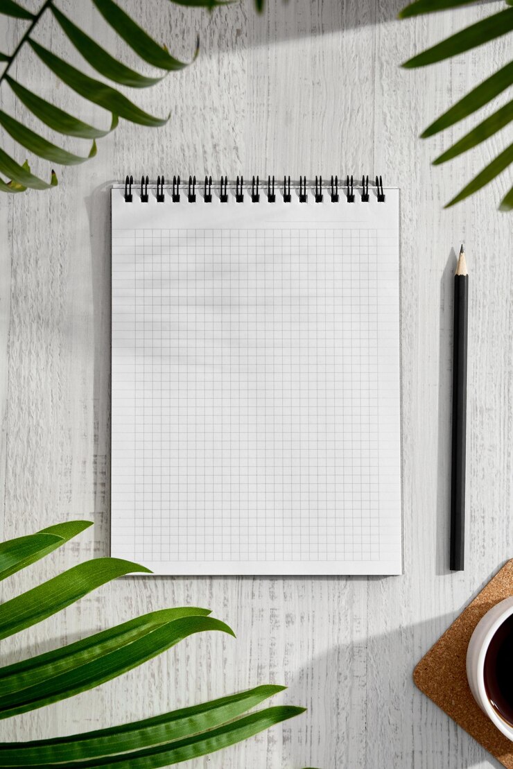 Escritorio con bloc de notas, lápiz, gafas de flores sobre un fondo de madera, diseño plano, concepto de vista superior