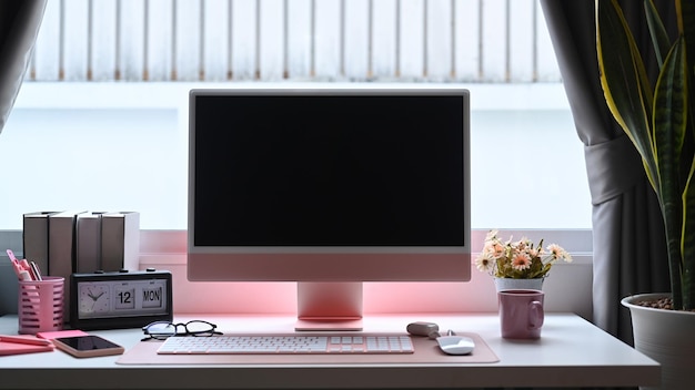 Escritório em casa moderno com computador e suprimentos na mesa branca