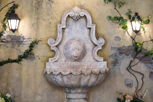 Escultura antigua de fuentes con cabeza de león.