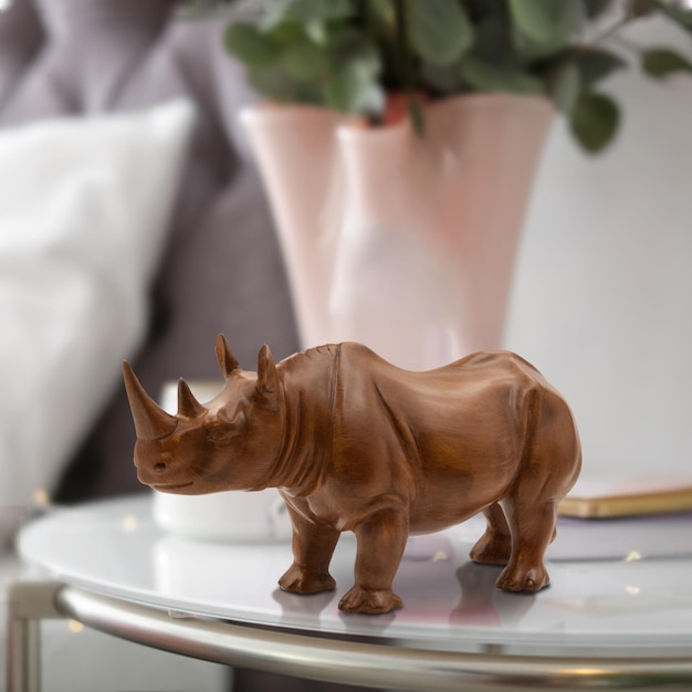 escultura de madeira de rinoceronte debaixo da mesa