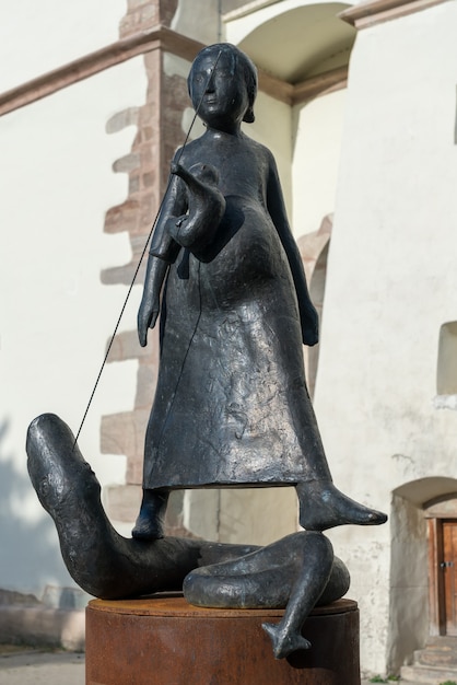 Escultura moderna em frente à Igreja Luterana na Bistrita Transilvânia, Romênia