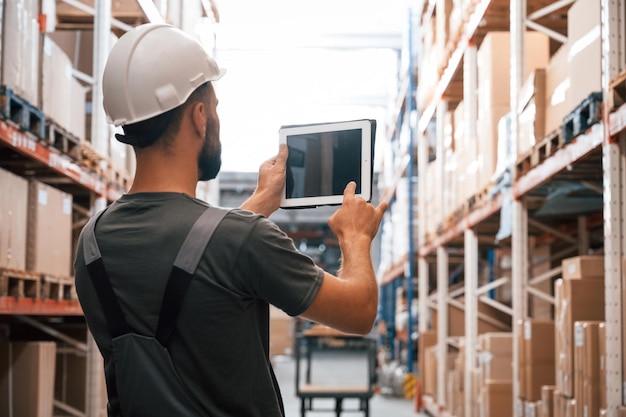 Espacio de copia que sostiene la tableta digital Foreman está en el negocio de distribución de envío de almacén