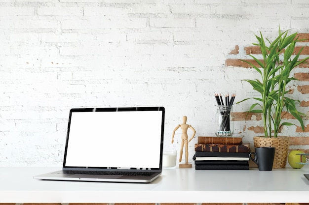 Espacio de trabajo Loft con computadora de pantalla en blanco en el escritorio de madera blanca.