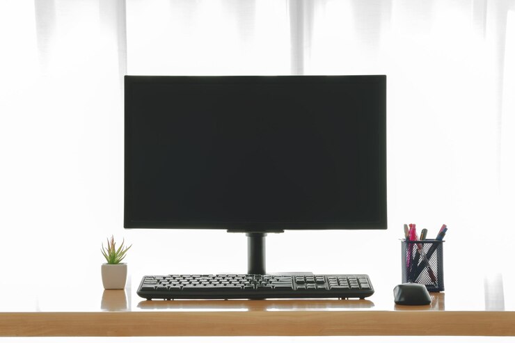 Foto espacio de trabajo con pantalla de computadora en blanco
