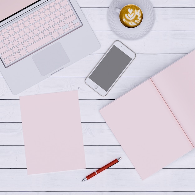 Espacio de trabajo rosa con café de papel de cuaderno y teléfono, vista superior