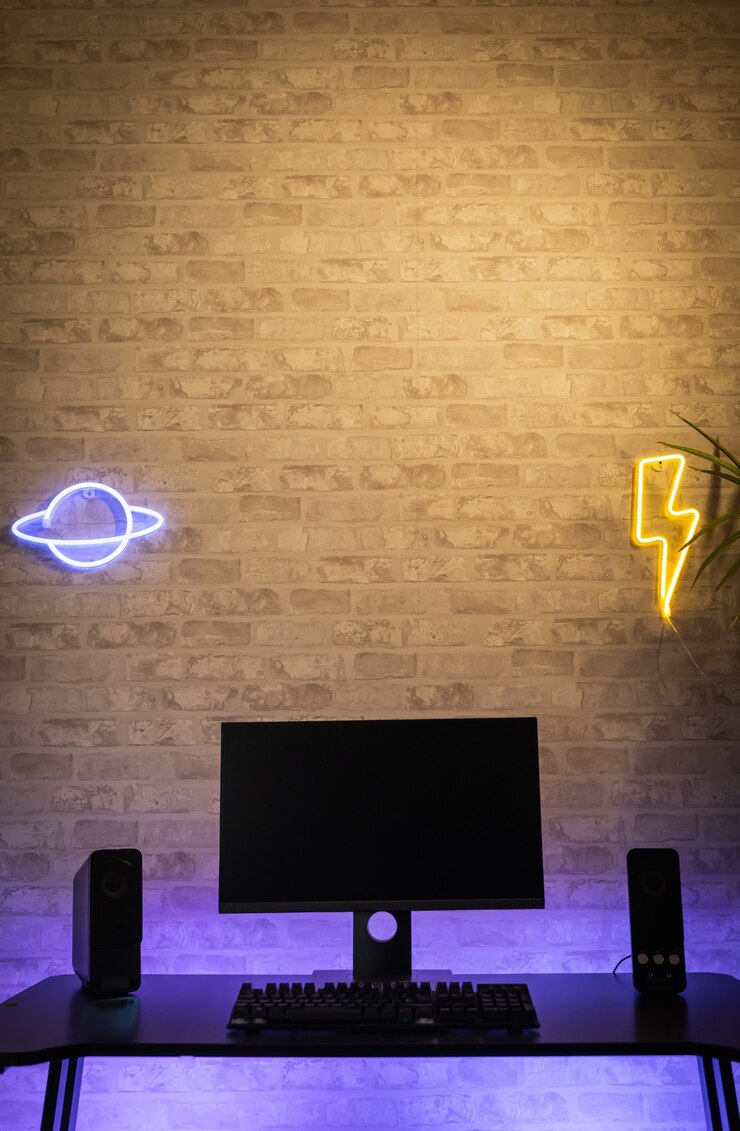 Foto espaço de trabalho do jogador de computador com monitor de tela preta com néons e luzes coloridas gamer rig