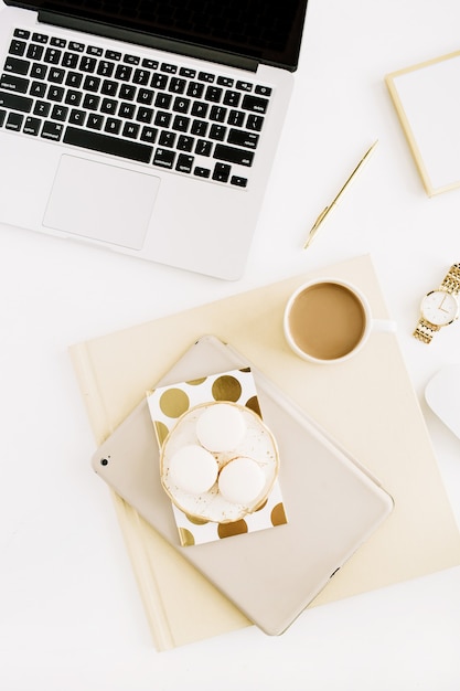 Espaço de trabalho feminino plano leigo com laptop, doces, café e acessórios femininos