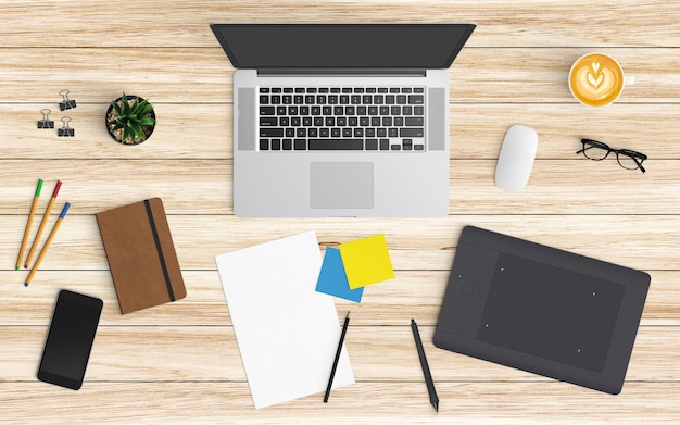 Espaço de trabalho moderno com xícara de café, papel, caderno, tablet ou smartphone e laptop na madeira