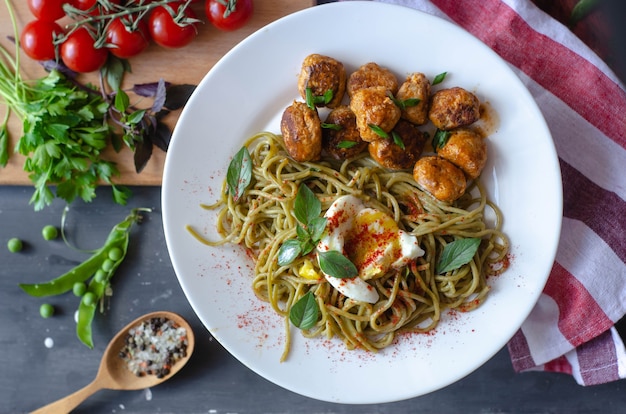 Espaguetis de espinacas con albóndigas y huevo