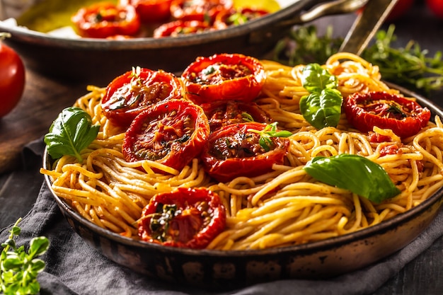 Espaguetis de pasta italiana con tomates asados, albahaca, orégano y tomillo.