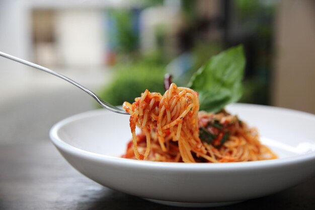 Espaguetis con salsa de tomate y albahaca fresca sobre madera, pasta italiana