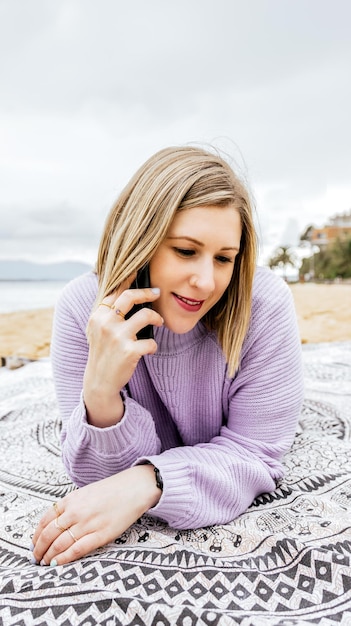 España Asturias joven y bella mujer con smartphone en la playa