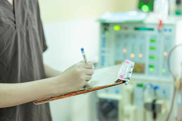 Foto el especialista está comprobando el equipo de terapia de reemplazo renal continua y la bomba de inyección y la máquina de hemodiálisis