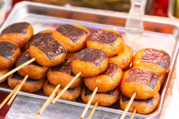 Espigas fritas comida callejera china en el barrio de Nankinmachi en Kobe, Japón