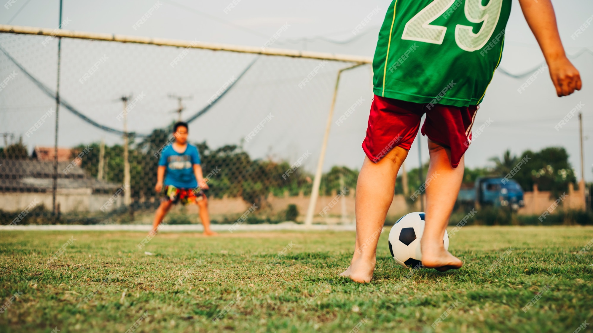 Crianças Jogam Jogo De Futebol. Crianças Em Duas Equipes Chutando Bola  Clássica De Futebol. Jovens Jogadores De Futebol Se Divertindo No Jogo De  Futebol De Verão Foto Royalty Free, Gravuras, Imagens e