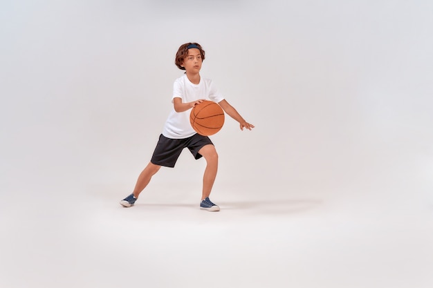 Esporte favorito foto completa de um adolescente jogando basquete em pé isolado