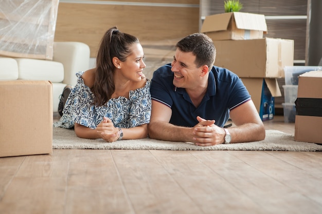 Esposa rindo da piada que o marido contou em seu novo apartamento. a alegria de um lindo casal