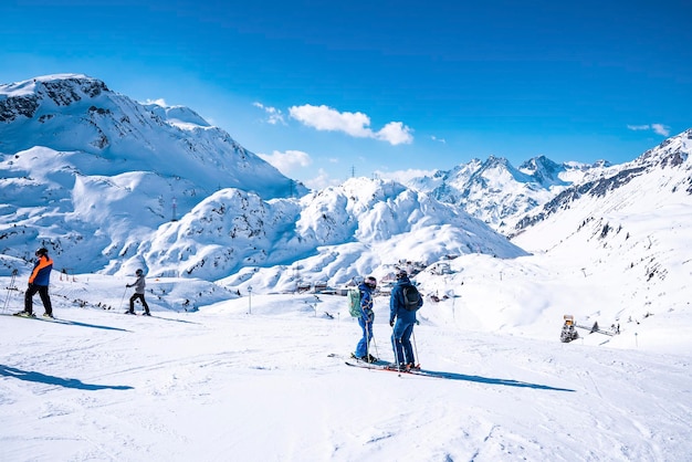 Esquiadores com postes em pé na encosta da montanha nevada na estância de inverno