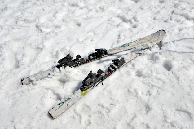 Esquís abandonados en la nieve. Vista superior. Concepto de fin de temporada de esquí.