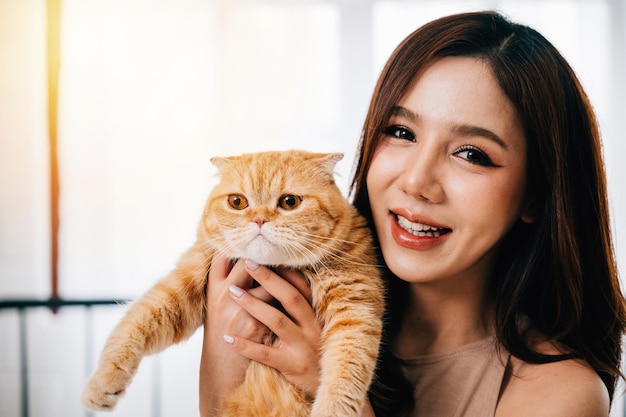 Esta foto em close-up retrata uma mulher e seu encantador gato laranja Scottish Fold destacando o calor e a companhia que eles desfrutam no conforto de sua casa