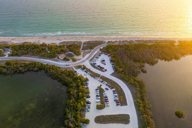 Estacionamento na praia de Florida Blind Pass em Manasota Key, EUA Área de estacionamento de veículos com carros estacionados no estacionamento da praia do oceano Férias de verão em frente à praia