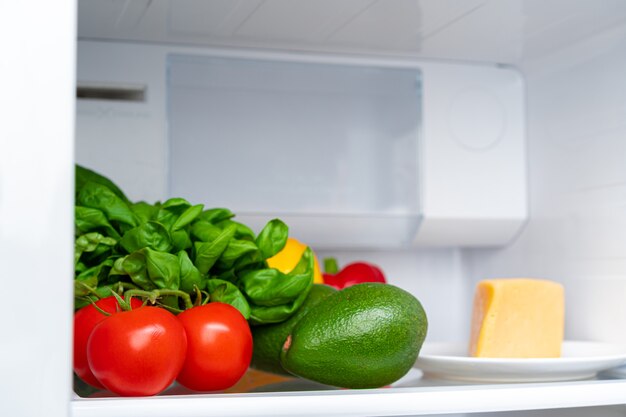 Estante del frigorífico lleno de verduras frescas cerrar