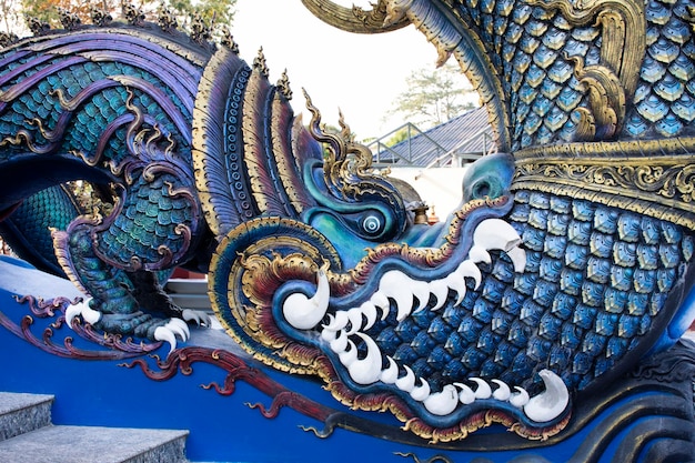 Estatua animal mítica estilo lanna en las escaleras para los tailandeses y los viajeros extranjeros visitan el templo Wat Rong Suea Ten el 22 de febrero de 2018 en Chiang Rai Tailandia