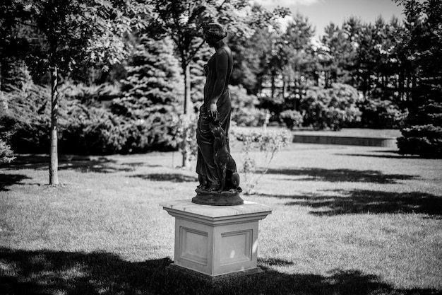 Estatua antigua de una niña en el parque. foto en blanco y negro